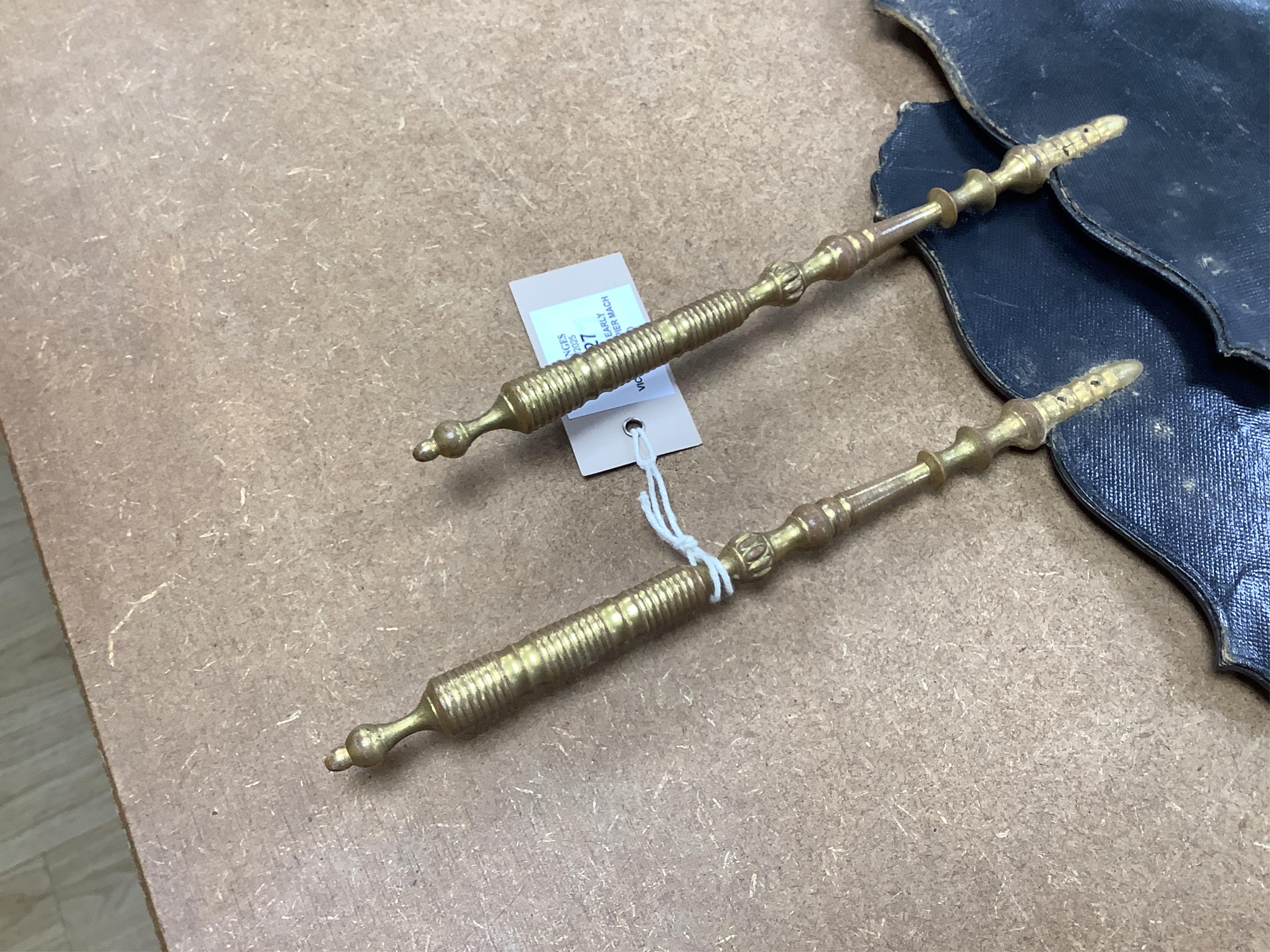 A pair of early Victorian papier maché hand screens, each with embroidered with cross stitched flowers, 41cm in length